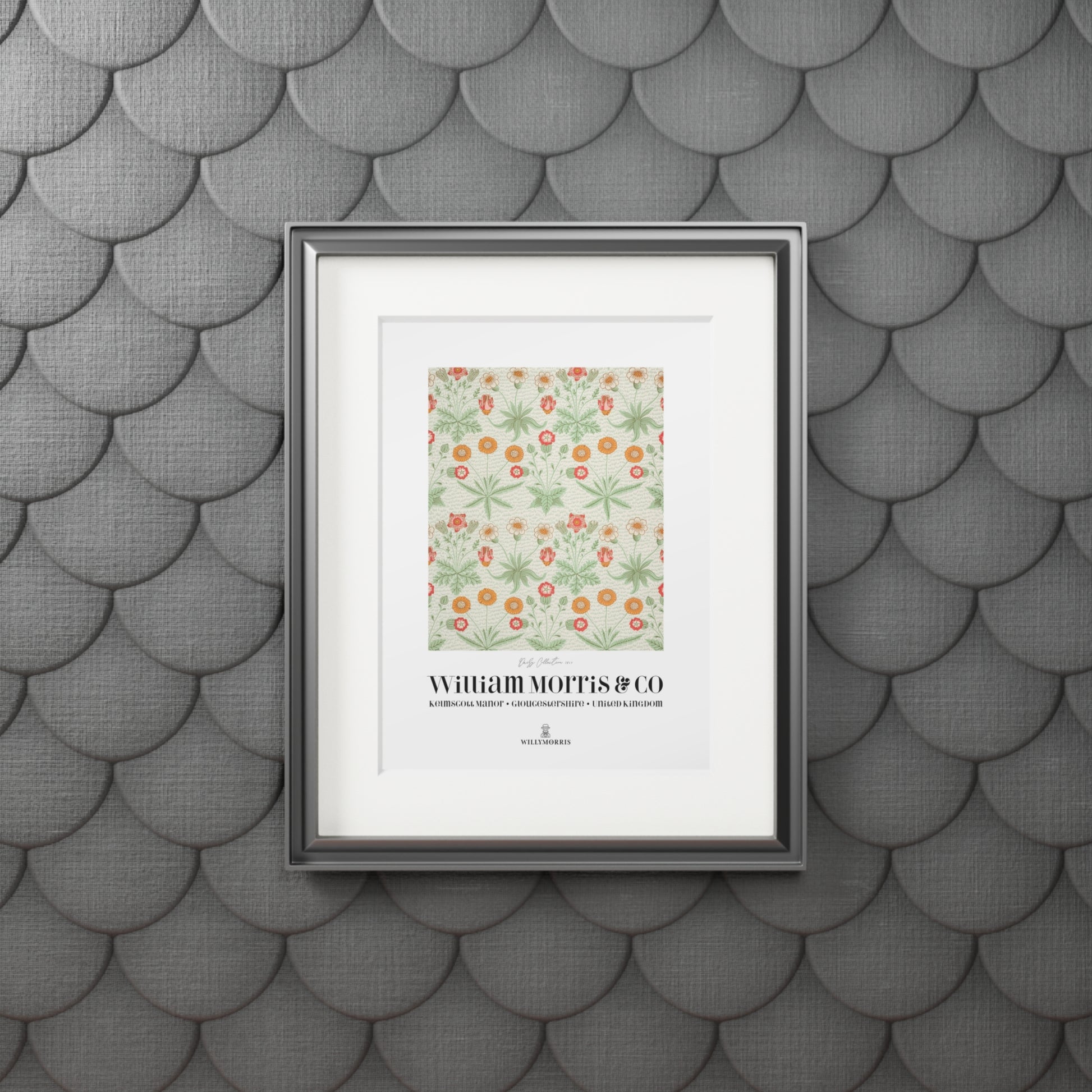 Framed artwork with a floral design and text on a textured gray wall.