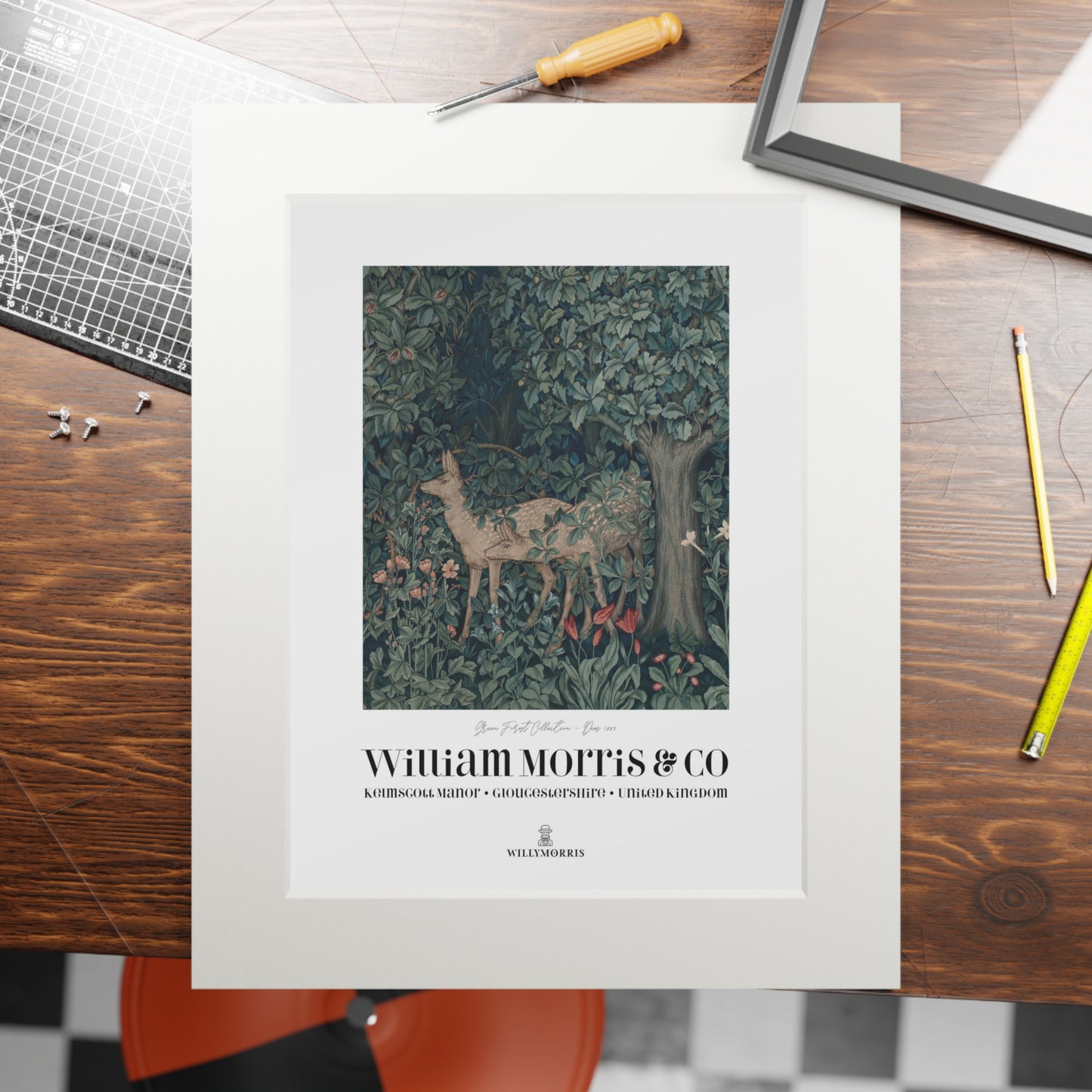 Framed artwork with a deer design on a wooden table, featuring William Morris & Co branding.