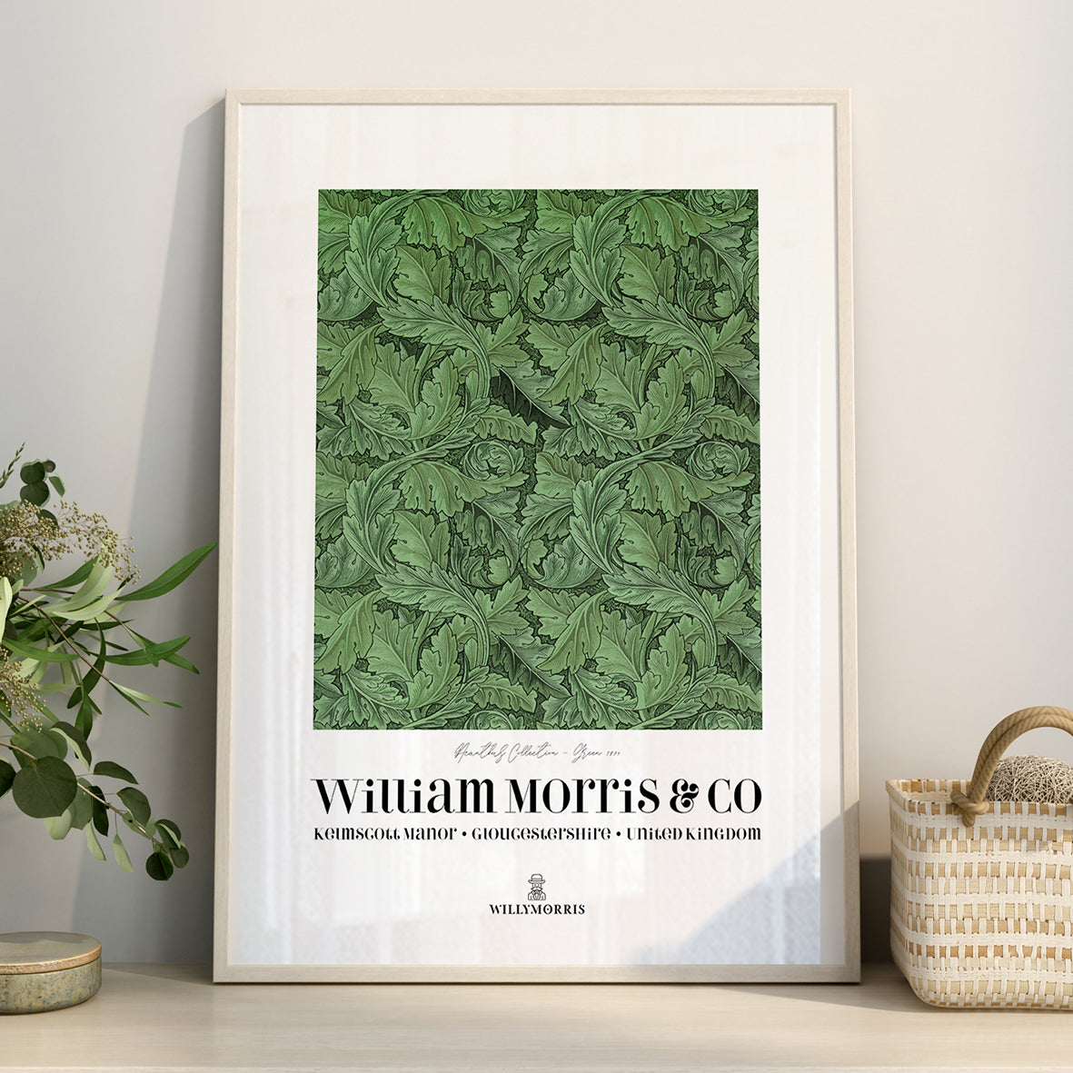Framed green patterned poster with 'William Morris & Co' branding on a light gray wall.