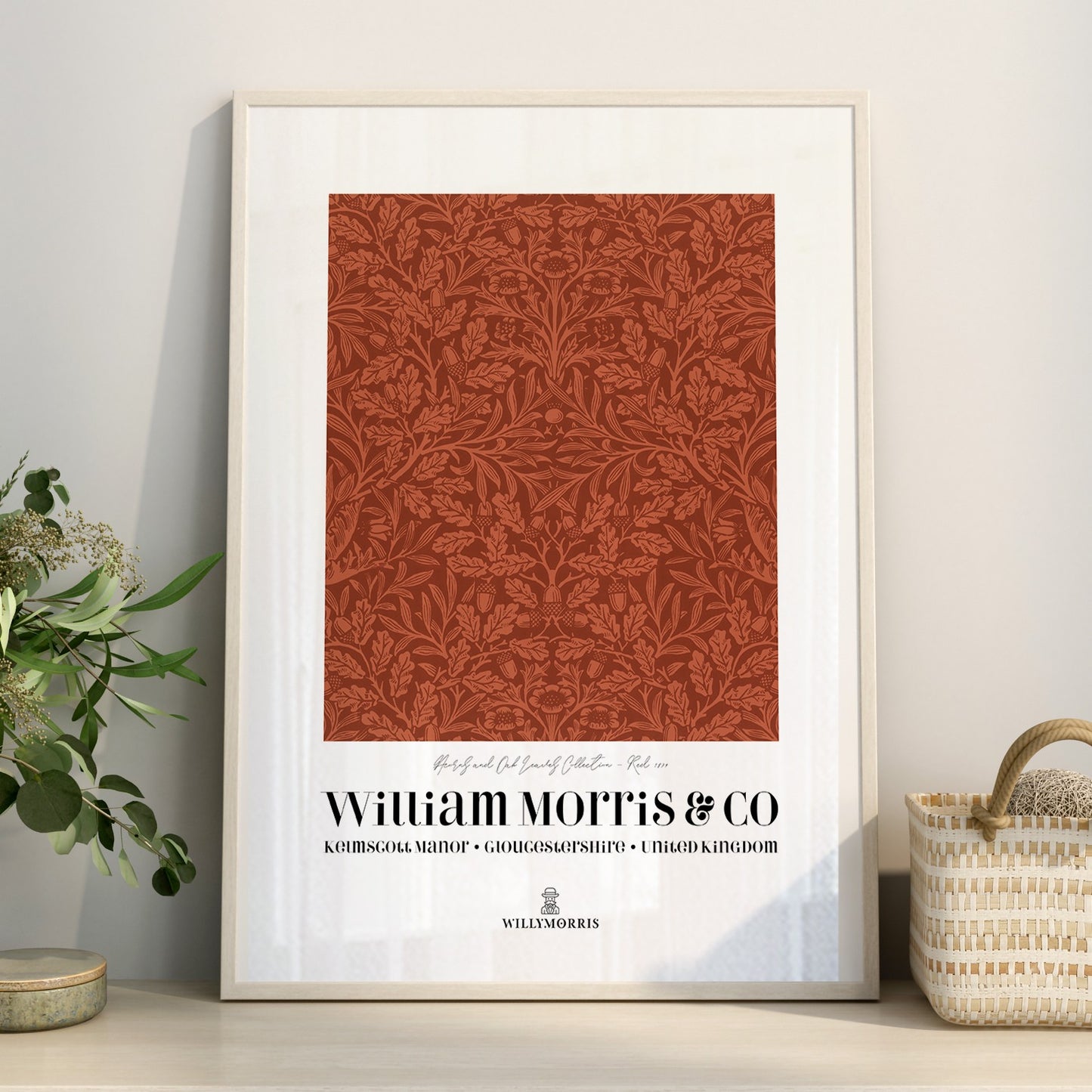 Framed William Morris & Co print with decorative pattern on a wall.