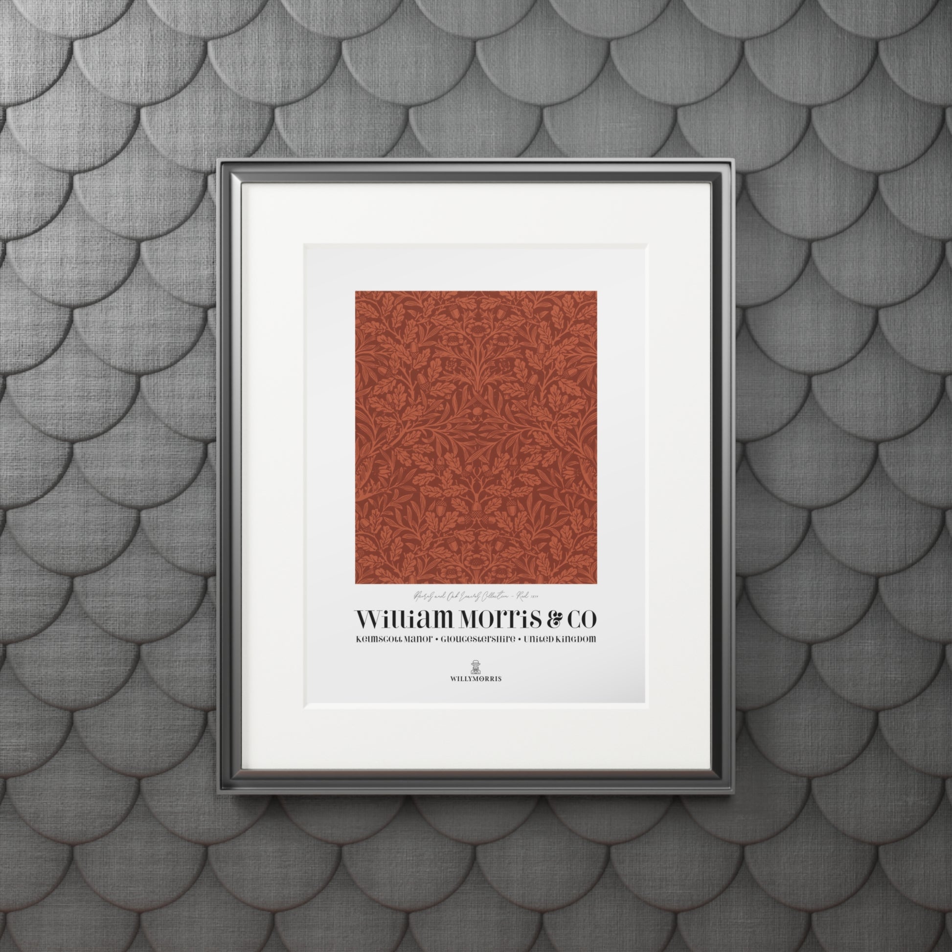 Framed artwork with a red pattern and text on a textured gray wall