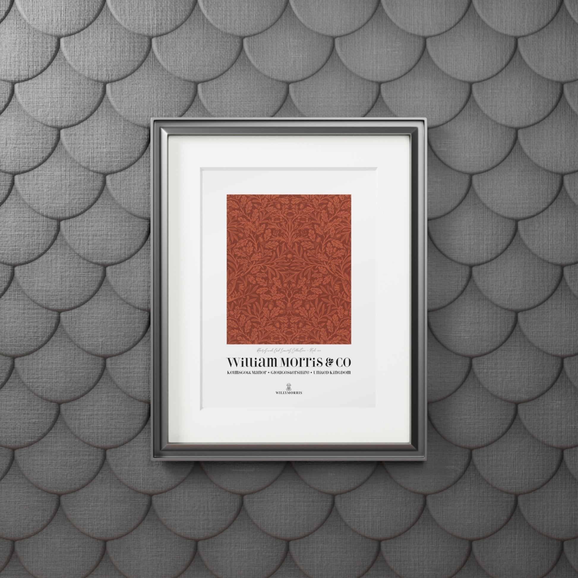 Framed artwork with a red pattern and text on a textured gray wall.