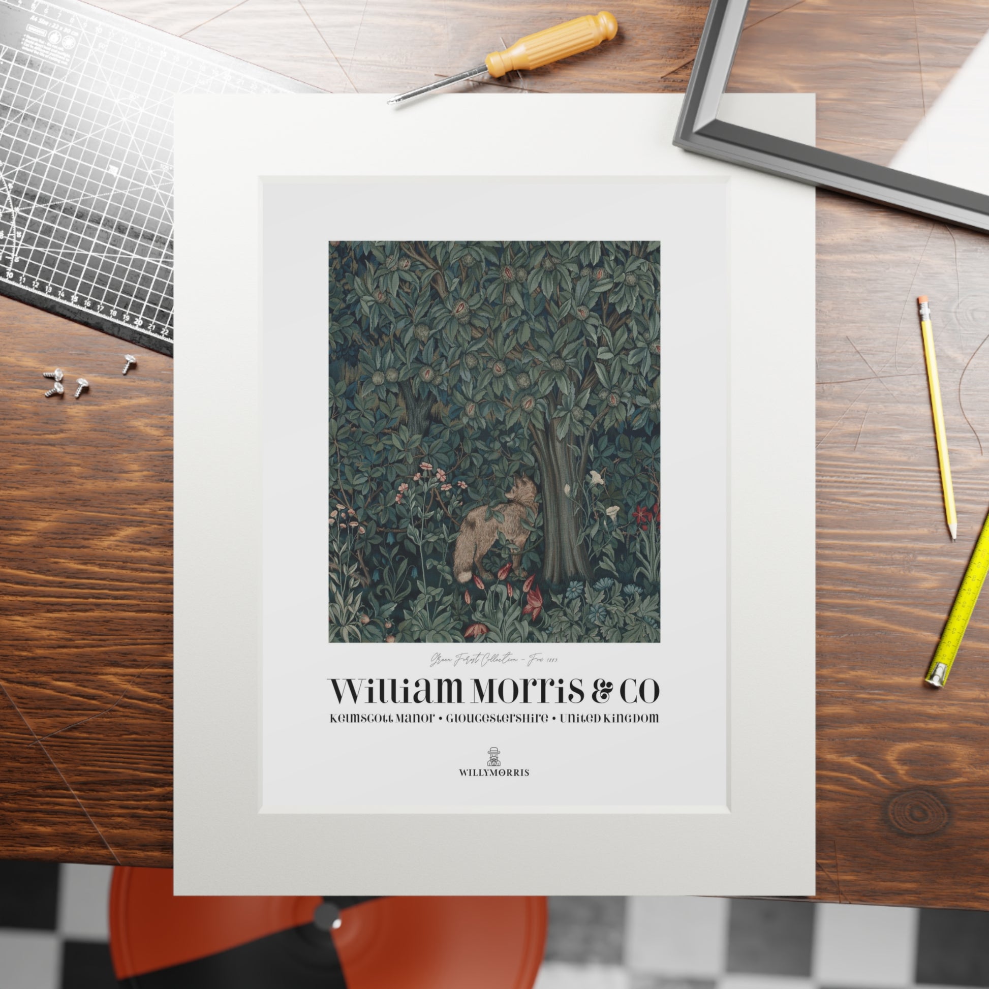 Framed artwork with William Morris & Co branding on a wooden table.