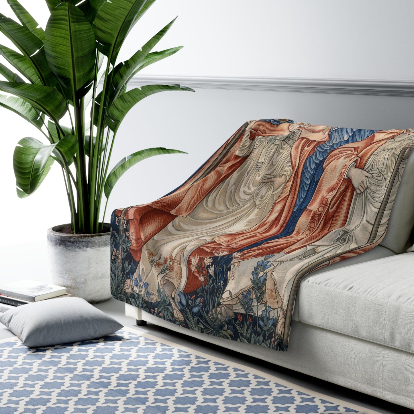 A Sherpa fleece blanket with a floral and angelic pattern inspired by William Morris' work.