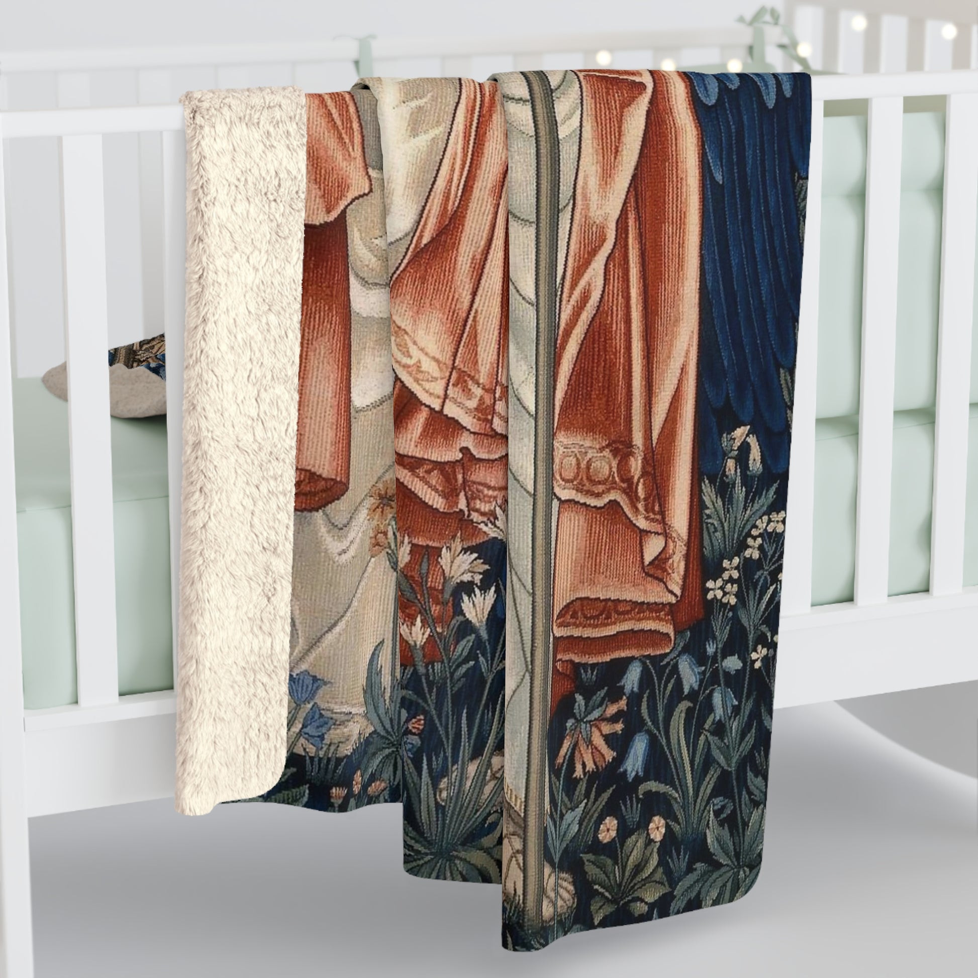 A Sherpa fleece blanket with a floral and angelic pattern inspired by William Morris' work.