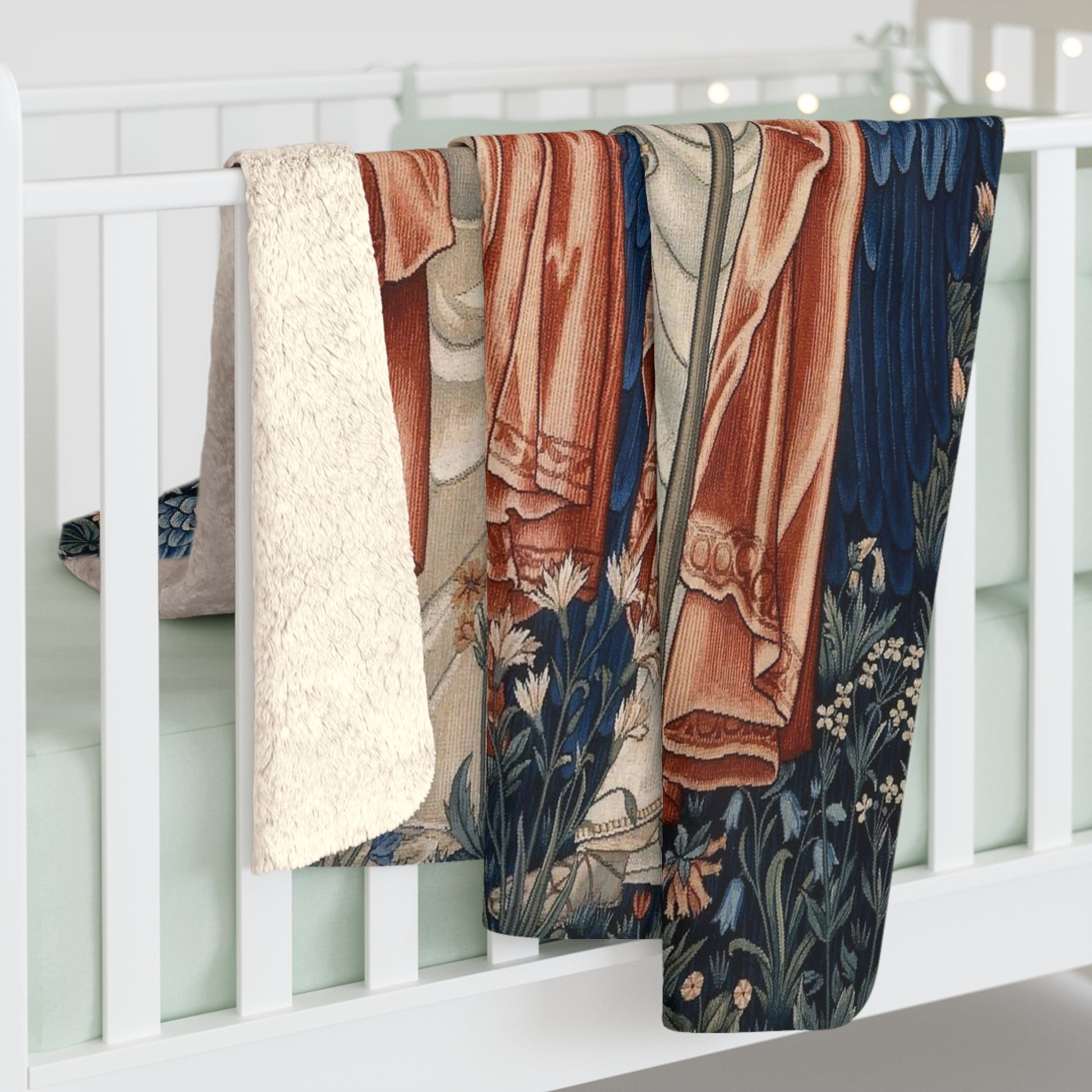 A Sherpa fleece blanket with a floral and angelic pattern inspired by William Morris' work.