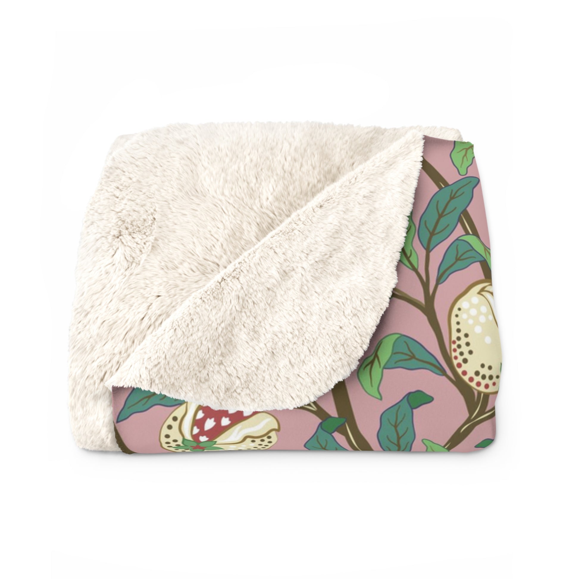 A plush fleece blanket with a floral William Morris & Co pattern featuring birds and pomegranate designs, predominantly in green and pink tones.