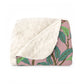 A plush fleece blanket with a floral William Morris & Co pattern featuring birds and pomegranate designs, predominantly in green and pink tones.