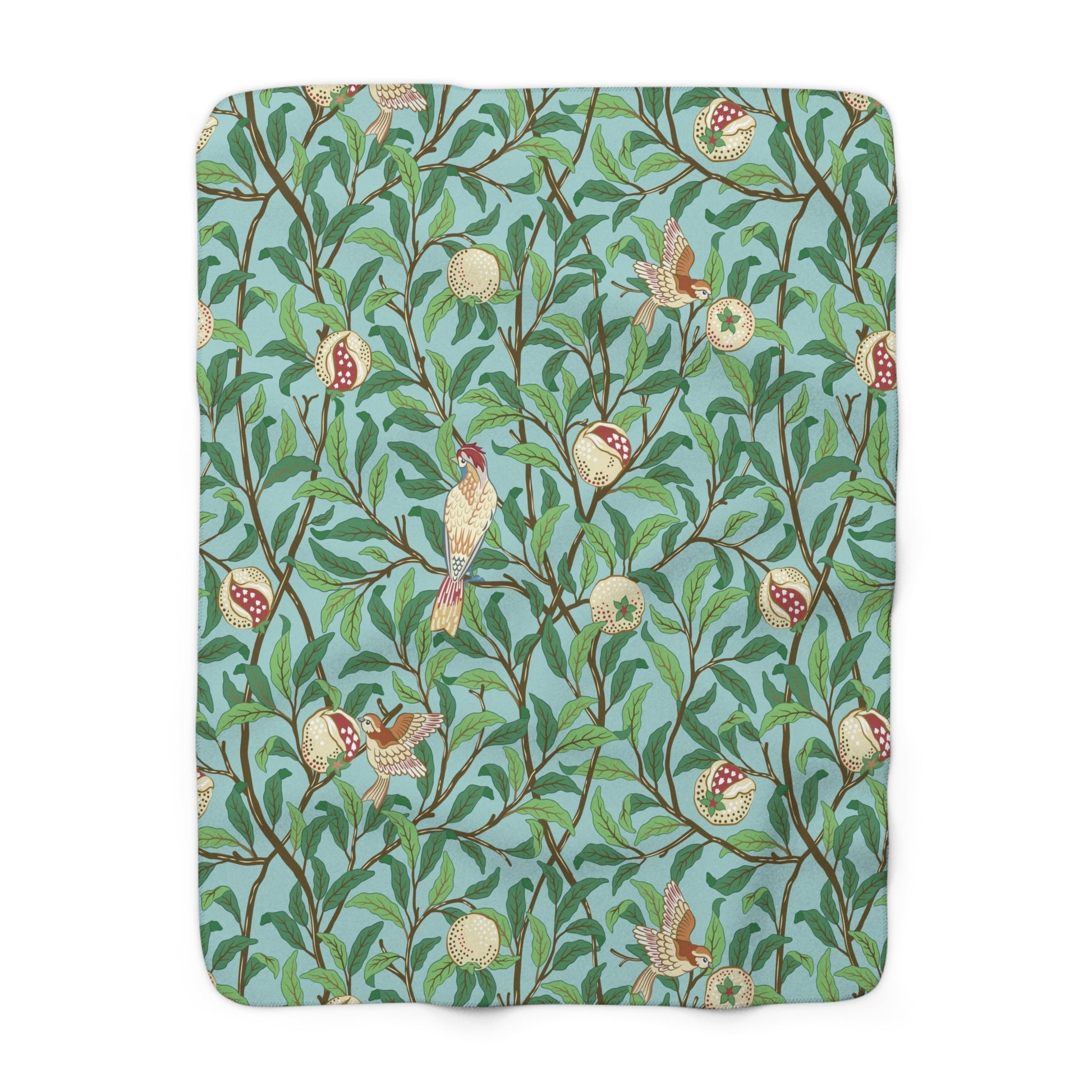 A Sherpa fleece blanket with an all-over print of birds and pomegranate fruits inspired by William Morris & Co on a blue background.