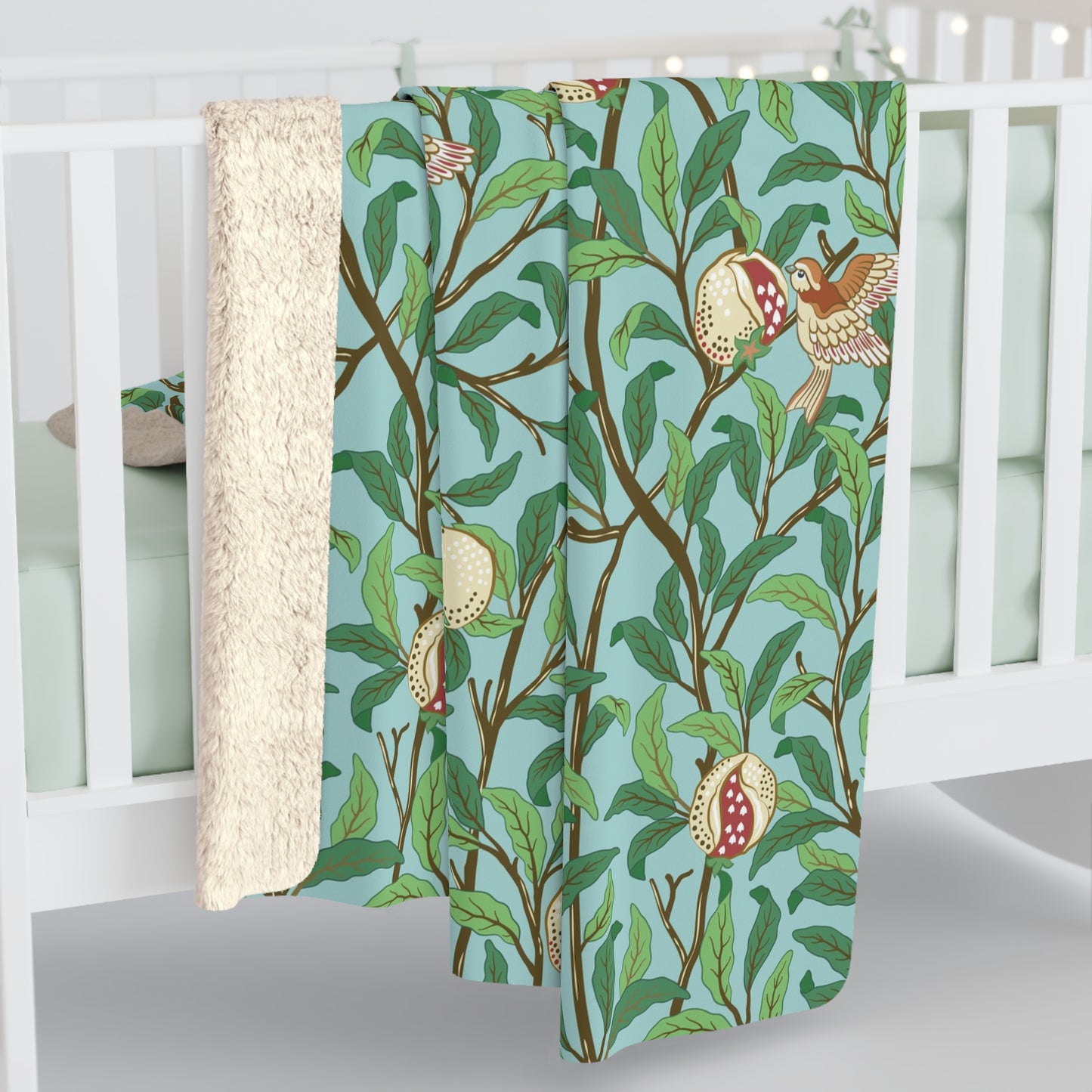 A Sherpa fleece blanket with an all-over print of birds and pomegranate fruits inspired by William Morris & Co on a blue background.