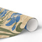 Gifts wrapped in decorative wrapping paper with William Morris & Co floral patterns, placed on a table alongside a roll of paper, scissors, and tags.