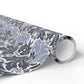 Roll of patterned paper with blue and white design on a white background