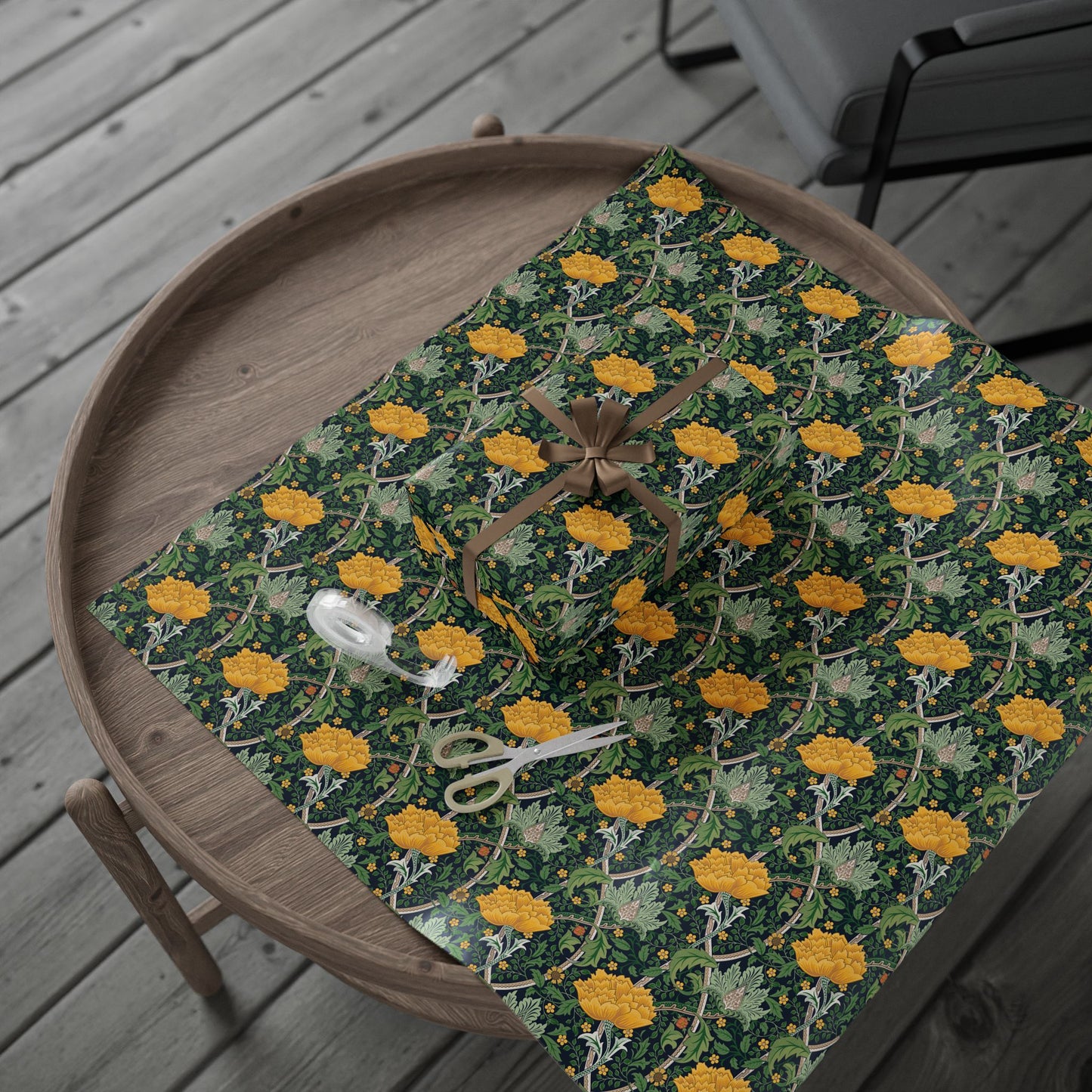 Patterned wrapping paper with yellow flowers on a wooden tray