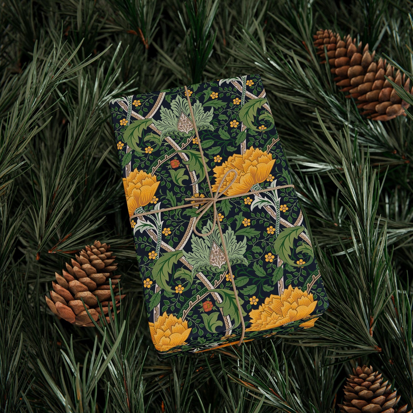 Patterned box with yellow flowers and green leaves on a background of pine needles and cones.