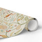 Roll of decorative paper with floral and nature-themed design on a white background