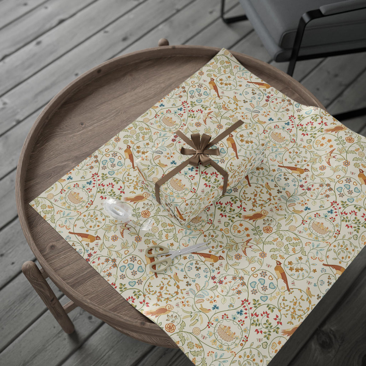 Decorative wrapping paper with floral and bird pattern on a wooden tray