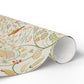 Roll of decorative paper with floral and nature-themed design on a white background