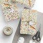 Gift boxes wrapped in decorative paper with a ball of twine, scissors, and tags on a white background.
