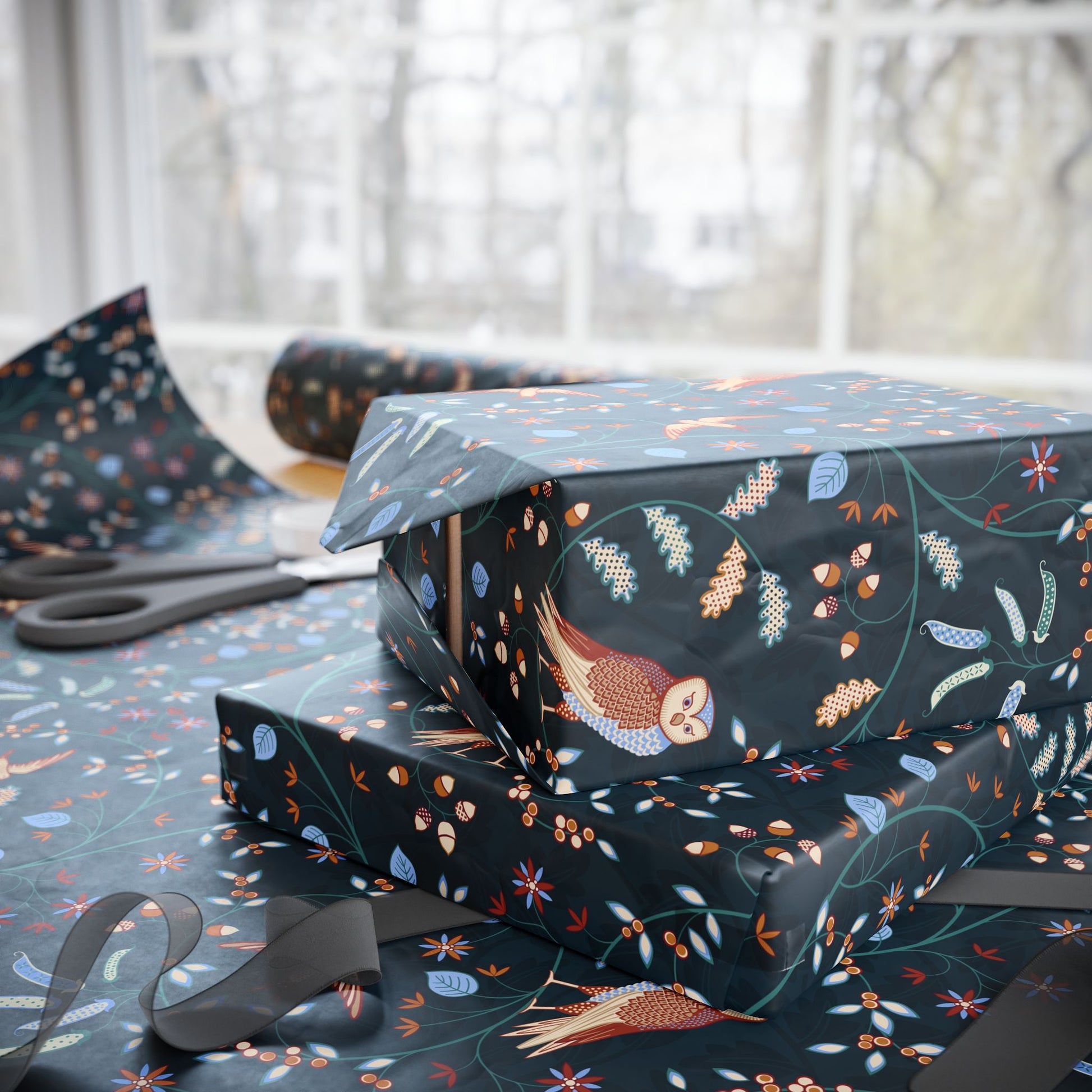 Gift boxes with owl and floral pattern on a table with scissors