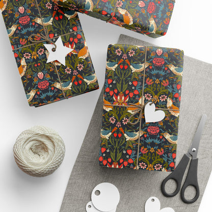 Gift wrapping paper with a floral and bird design, in ebony color, displayed alongside a roll of string and scissors.