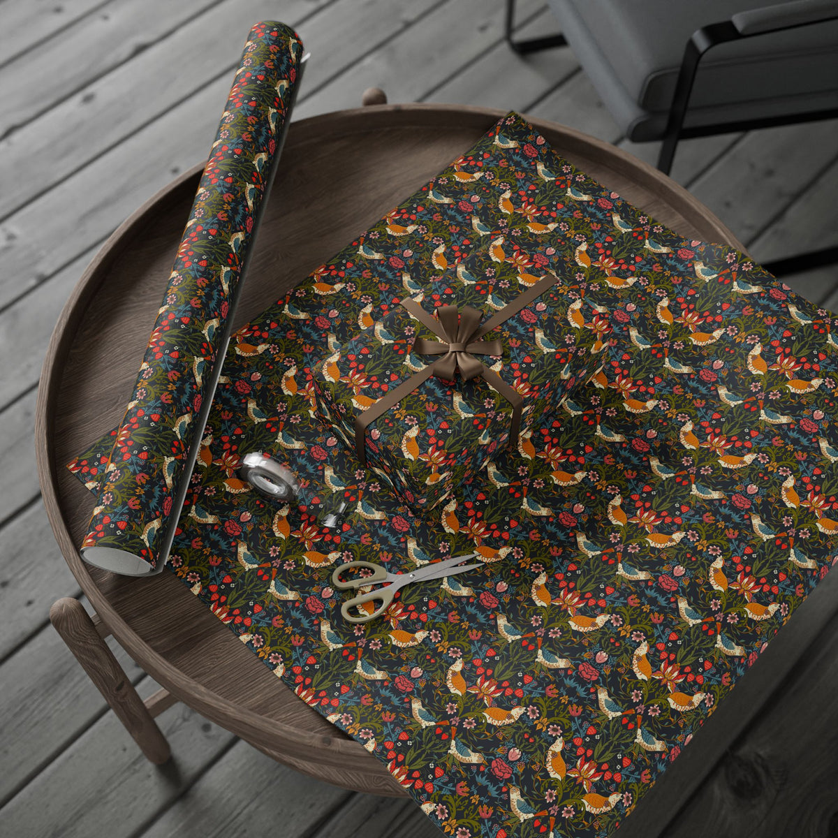 Floral-patterned fabric with sewing tools on a wooden surface