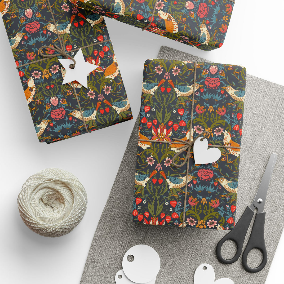 Gift wrapping with floral pattern, string, and scissors.