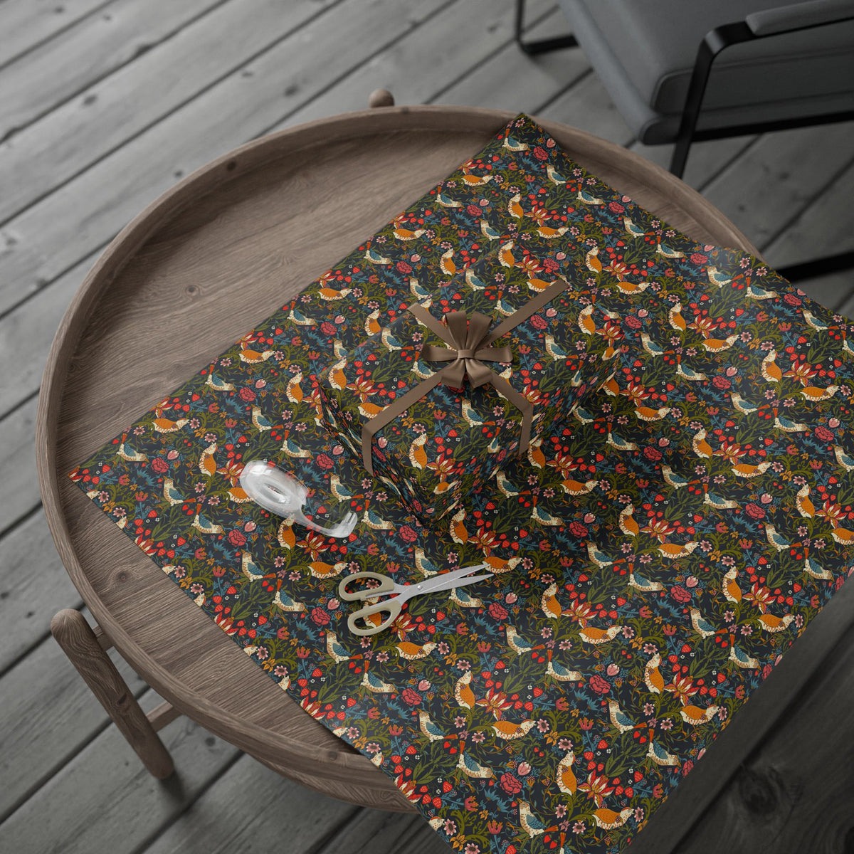 Fabric with fox and floral pattern on a wooden table.