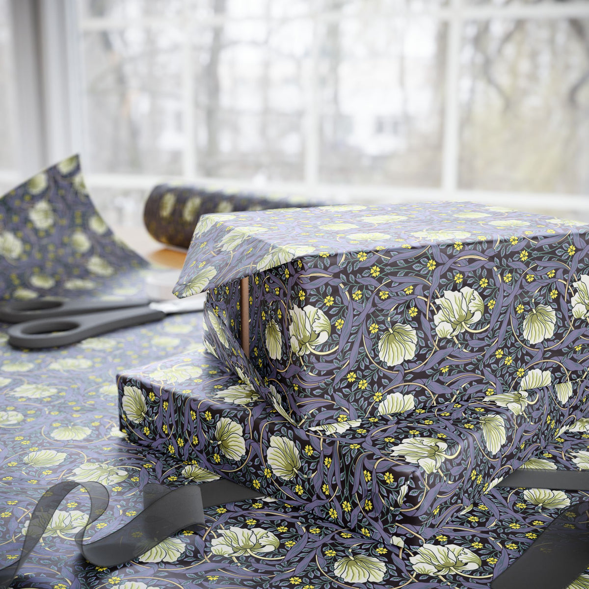 Floral-patterned fabric on a table with scissors in the background