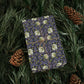Decorative box with floral pattern on a bed of pine needles and pine cones