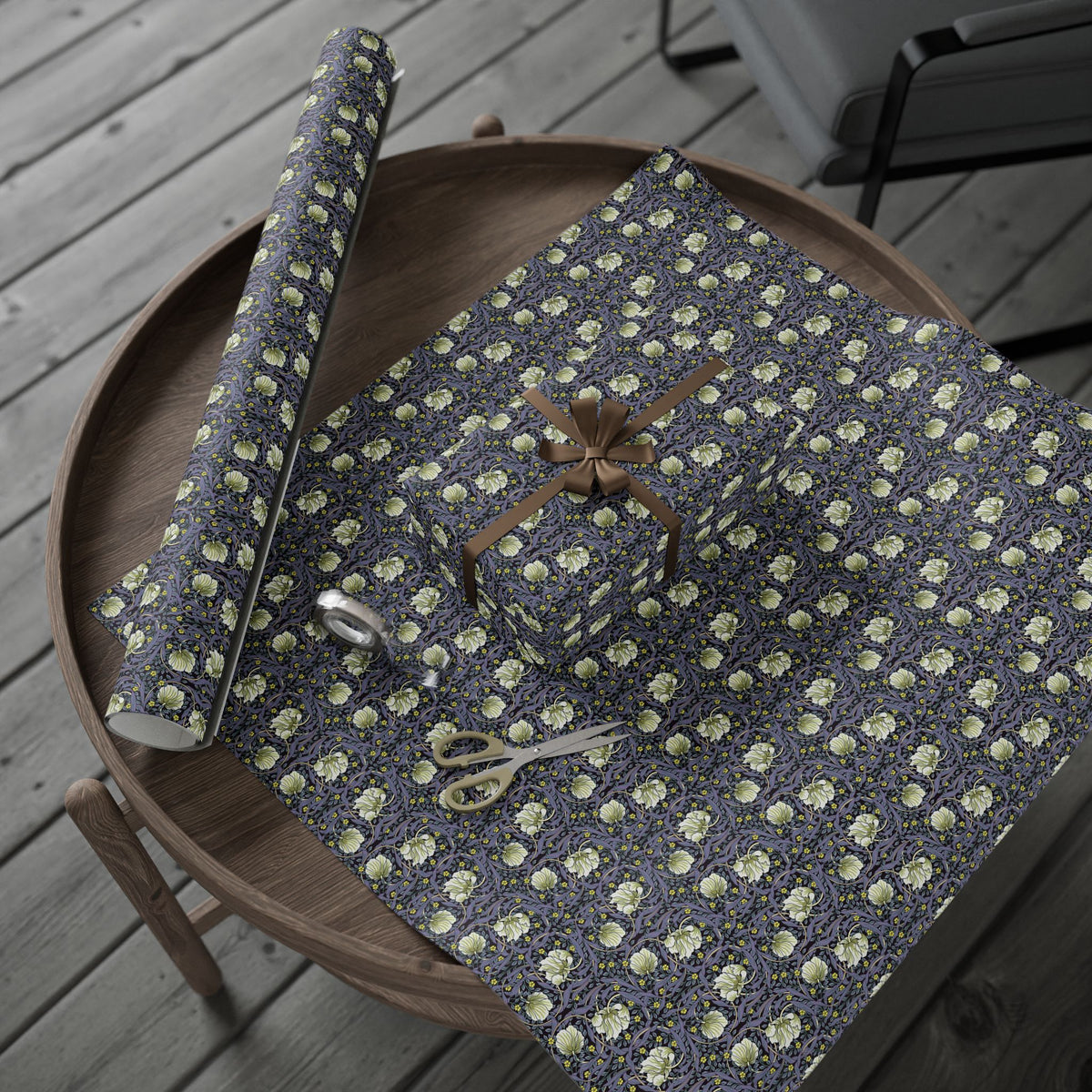 Floral-patterned paper with scissors on a wooden surface