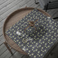 Gift box with floral pattern on a wooden tray