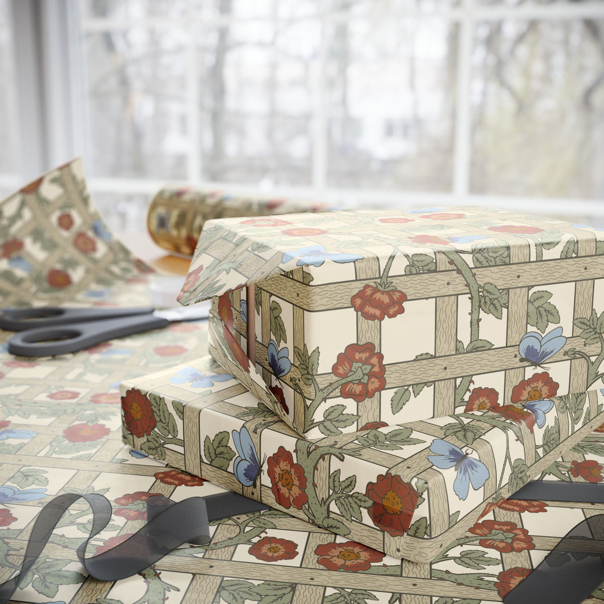 Gift box wrapped in floral-patterned paper with scissors on a matching surface.