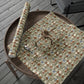 Floral-patterned paper and scissors on a wooden tray outdoors