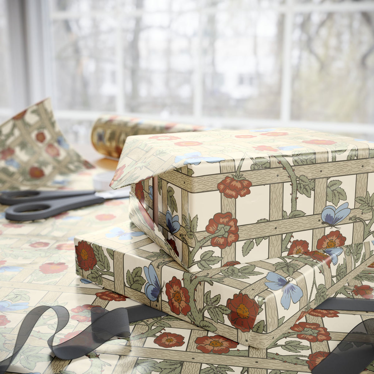 Floral-patterned gift box with ribbons on a table with scissors