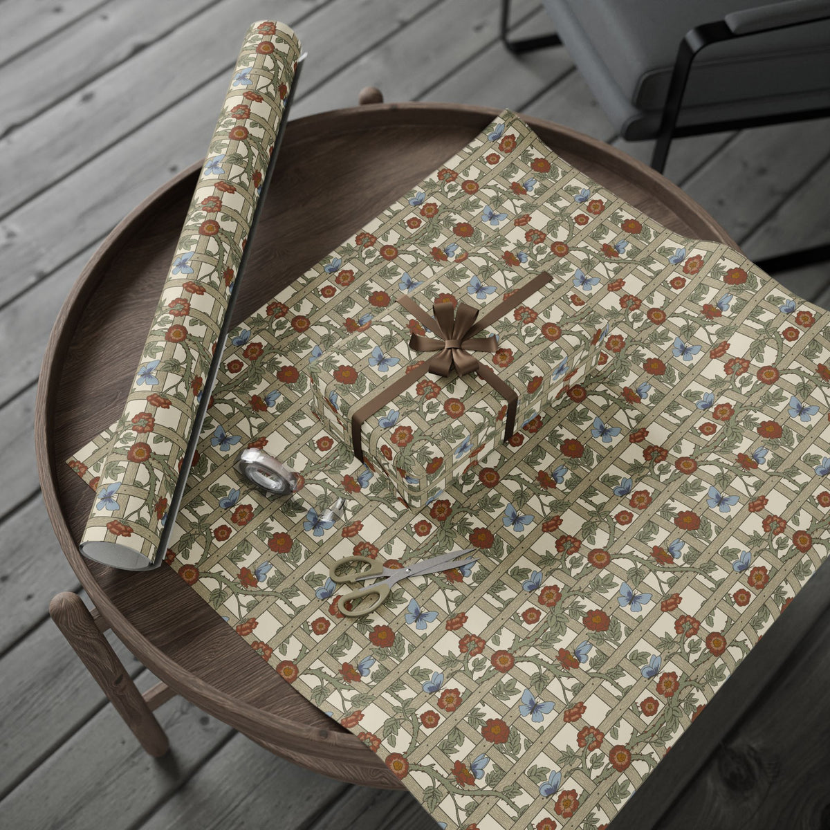 Floral-patterned paper with scissors on a wooden tray outdoors