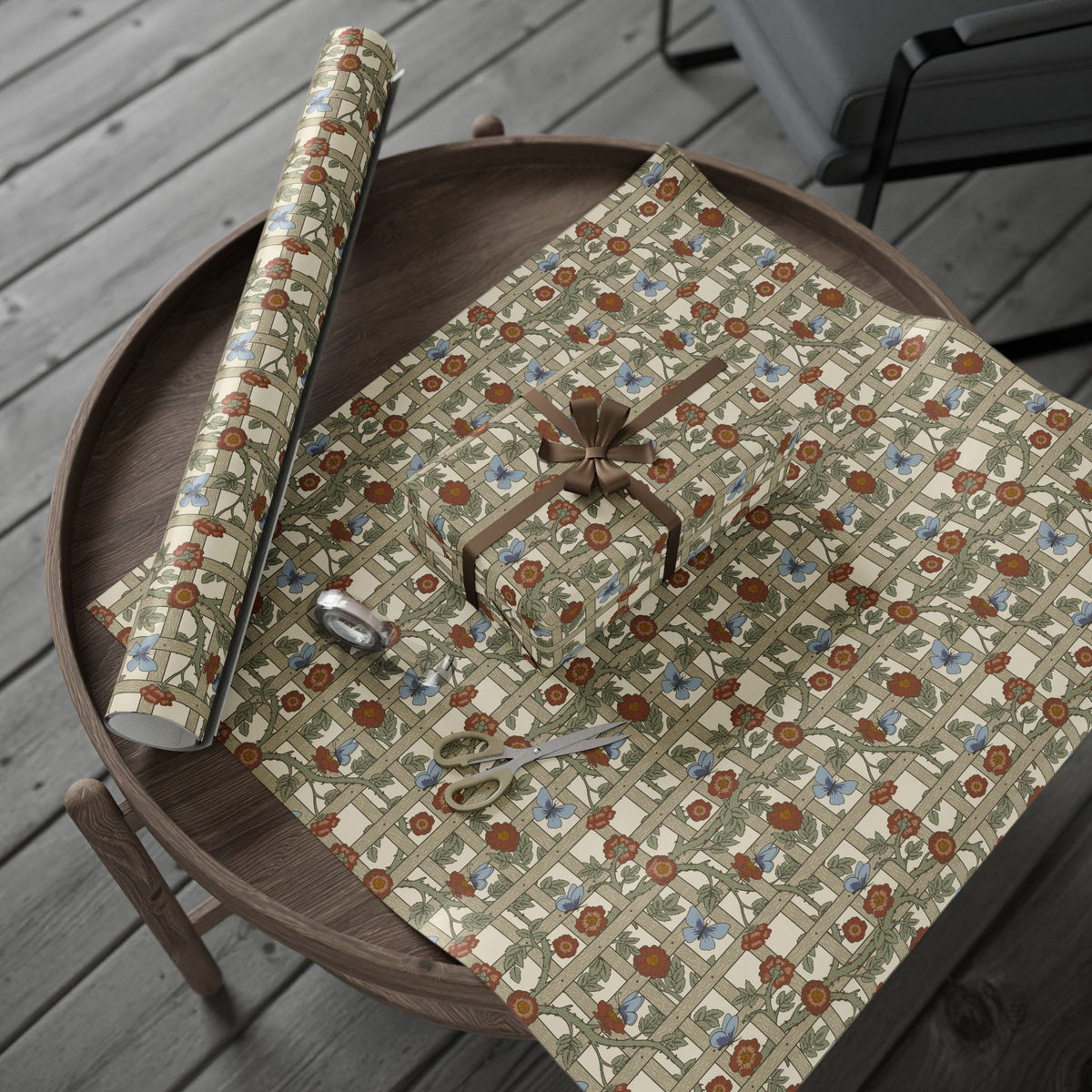 Floral-patterned paper and scissors on a wooden tray outdoors