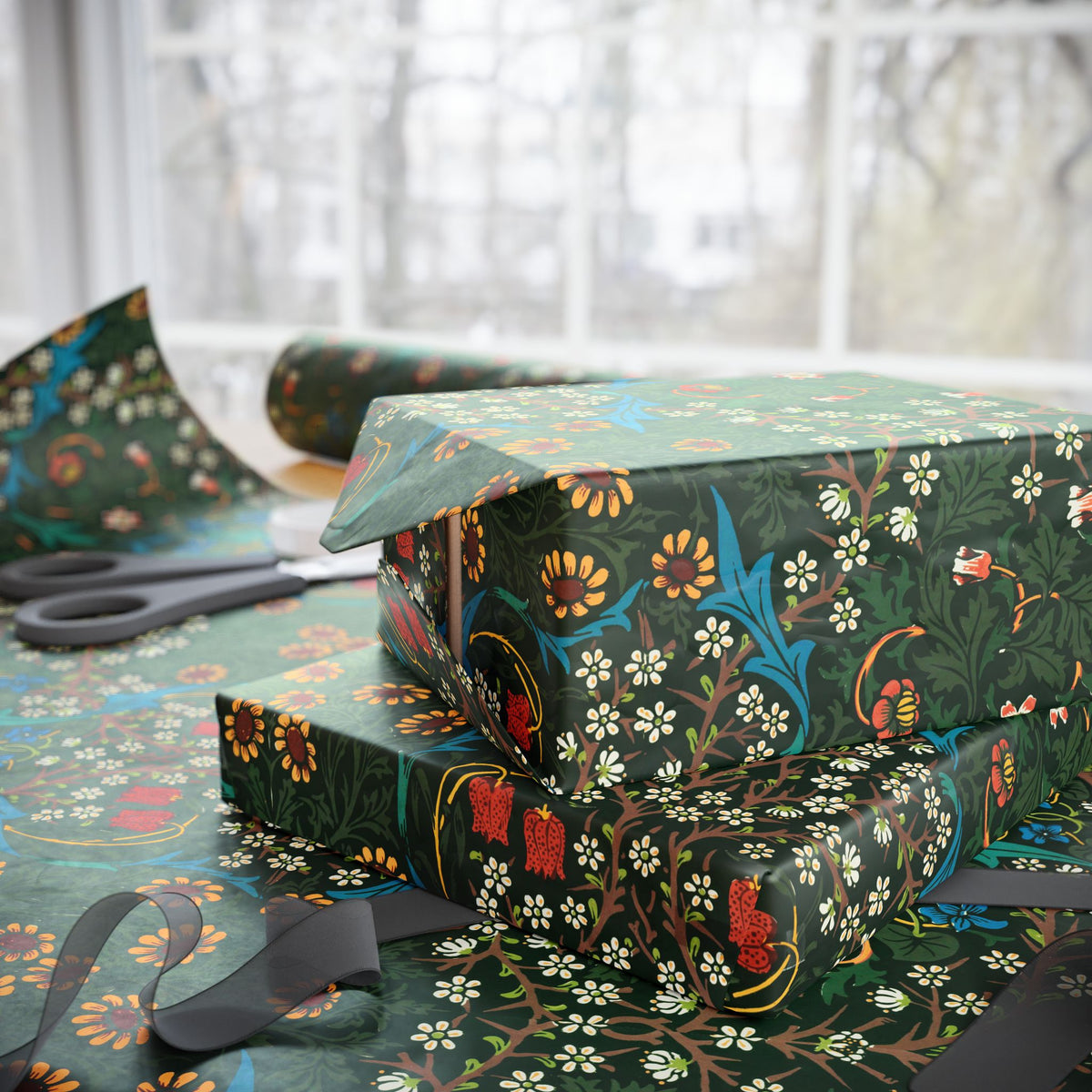 Gift box wrapped in floral-patterned paper with scissors on a matching tablecloth.
