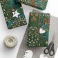 Gift boxes with floral patterns, tags, yarn, and scissors on a white surface