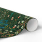 Roll of green floral and bird patterned paper on a white background