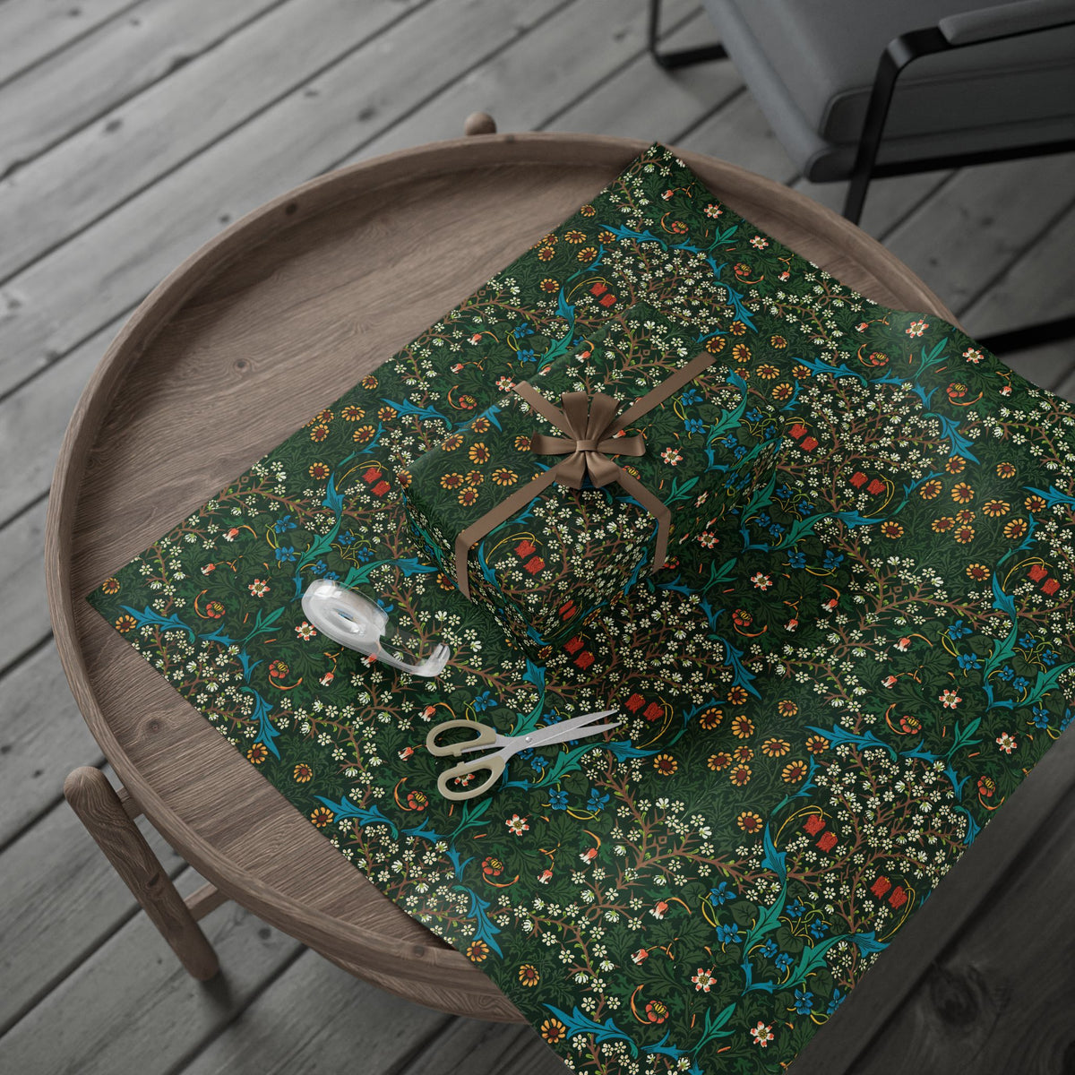Floral-patterned green fabric on a wooden tray with scissors and thread.