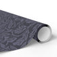 Roll of dark gray patterned vinyl wrap on a white background