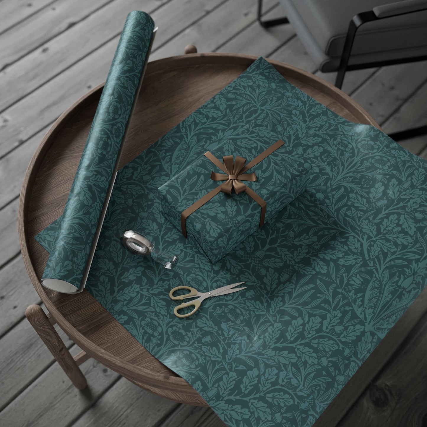Green patterned gift wrap with scissors on a wooden table