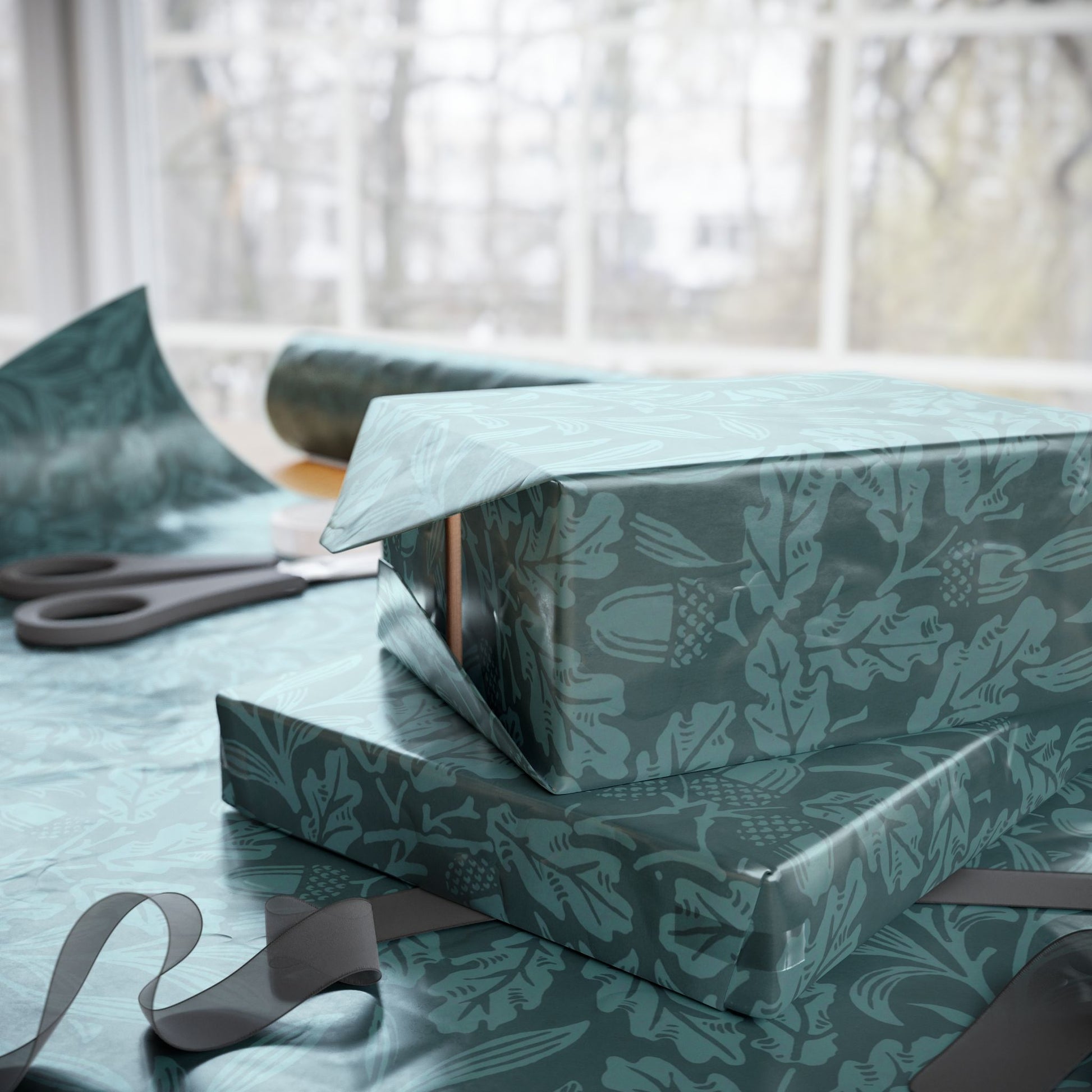 Two wrapped presents with a decorative pattern on a table with scissors in the background.