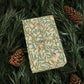 Gift box with decorative paper featuring birds and leaves, surrounded by pine branches and cones.