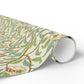 Roll of decorative paper with nature-themed design on a white background