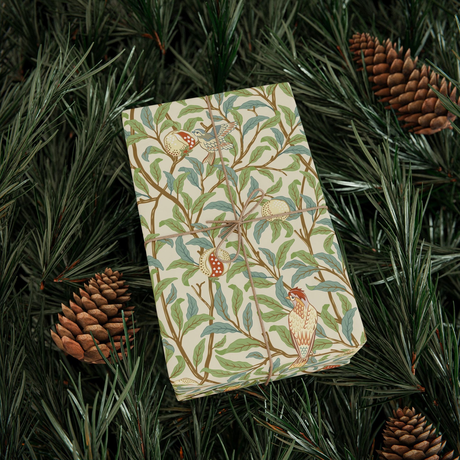 Folded fabric with bird and leaf pattern on a bed of pine needles and cones