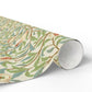 Roll of decorative paper with intricate floral pattern on a white background