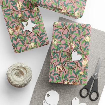 Gift boxes with pink floral pattern, scissors, twine, and tags on a white surface