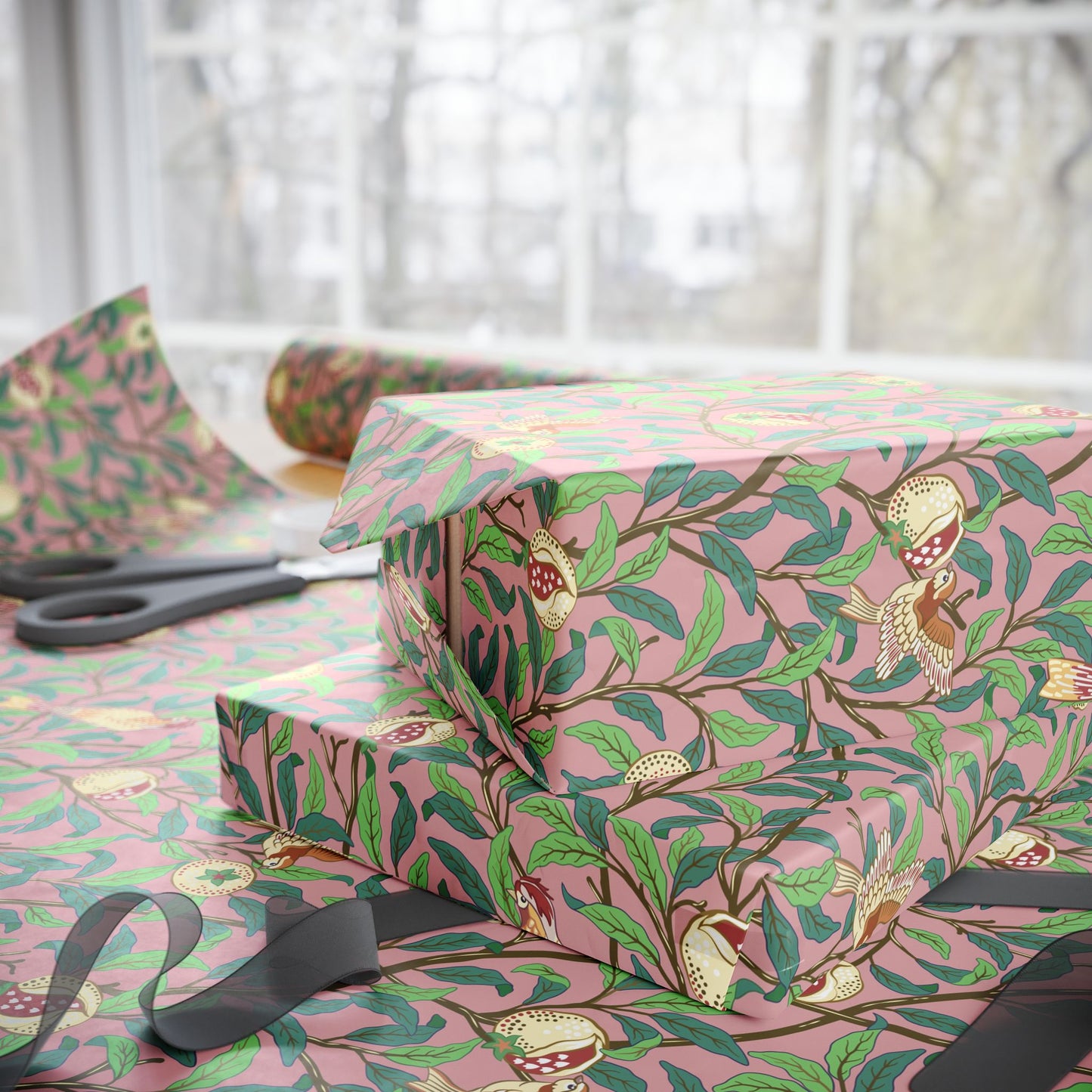 Gift boxes wrapped in pink floral-patterned paper with scissors on a matching surface.