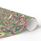 Roll of floral-patterned paper with green leaves and pink background on a white surface